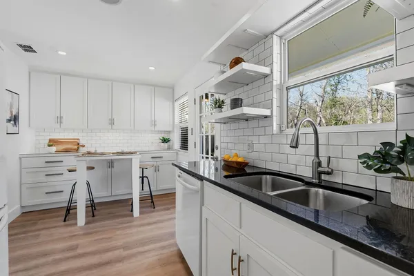 a kitchen that has a sink and a stove