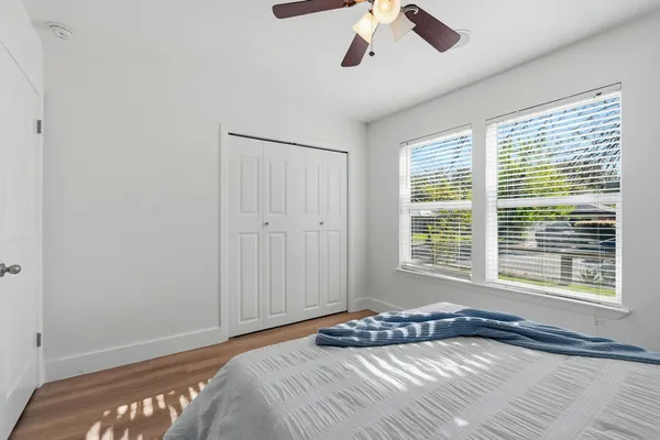 a bedroom with a bed and a window