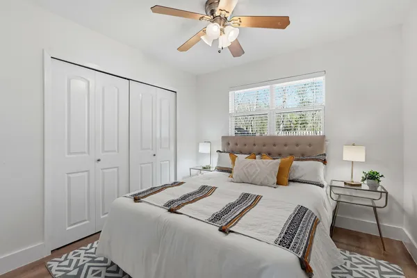 a bedroom with a bed and a chandelier
