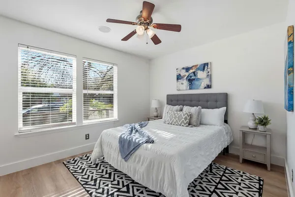 a bedroom with a bed and a chandelier