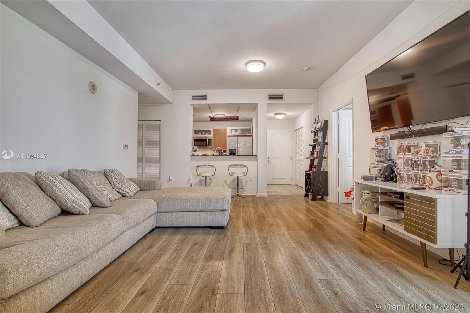 7355 Southwest 89th Street, Unit 425N Miami, FL 33156 - Photo 2 of 22 a living room with furniture and a flat screen tv