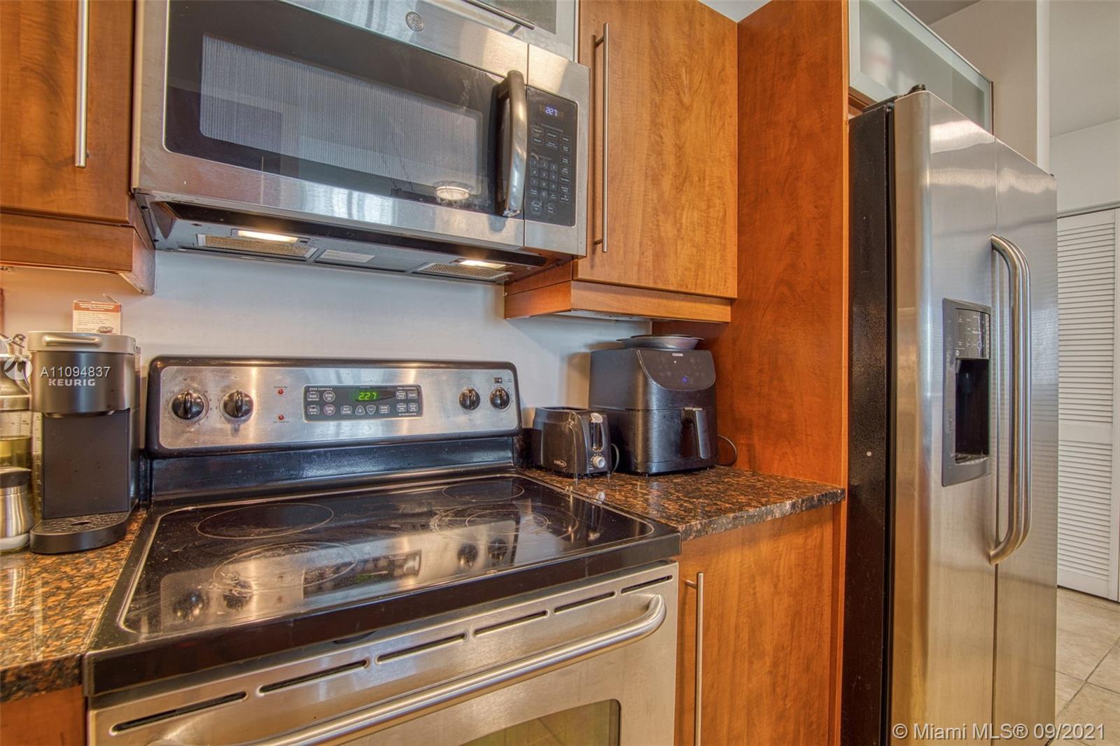 7355 Southwest 89th Street, Unit 425N Miami, FL 33156 - Photo 11 of 22 a stove top oven sitting inside of a kitchen