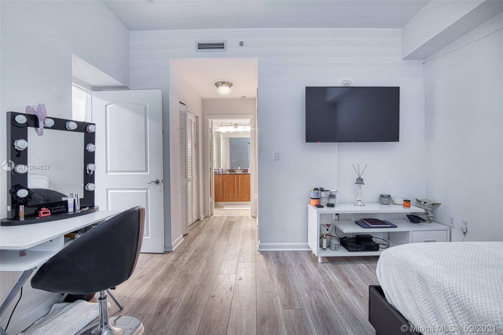 7355 Southwest 89th Street, Unit 425N Miami, FL 33156 - Photo 16 of 22 a living room with furniture and a flat screen tv