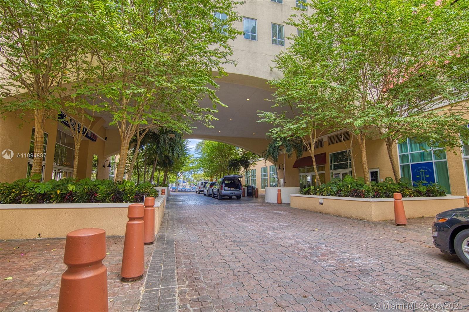 7355 Southwest 89th Street, Unit 425N Miami, FL 33156 - Photo 22 of 22 a view of a patio with table and chairs potted plants and large tree