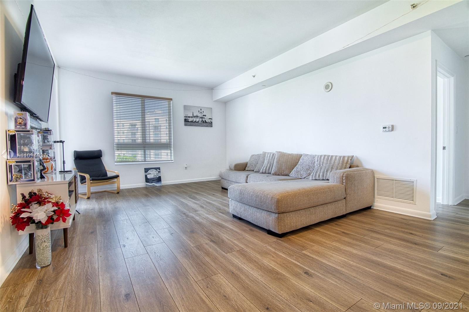 7355 Southwest 89th Street, Unit 425N Miami, FL 33156 - Photo 5 of 22 a living room with furniture and a flat screen tv