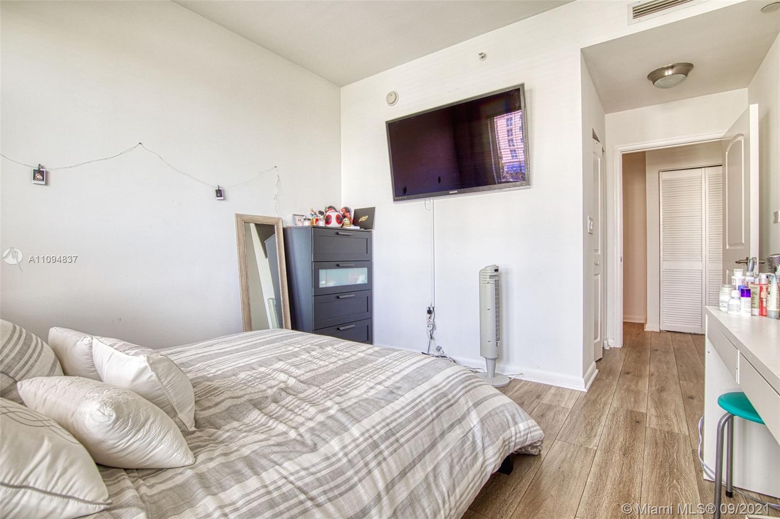 7355 Southwest 89th Street, Unit 425N Miami, FL 33156 - Photo 8 of 22 a bedroom with a bed and a flat screen tv