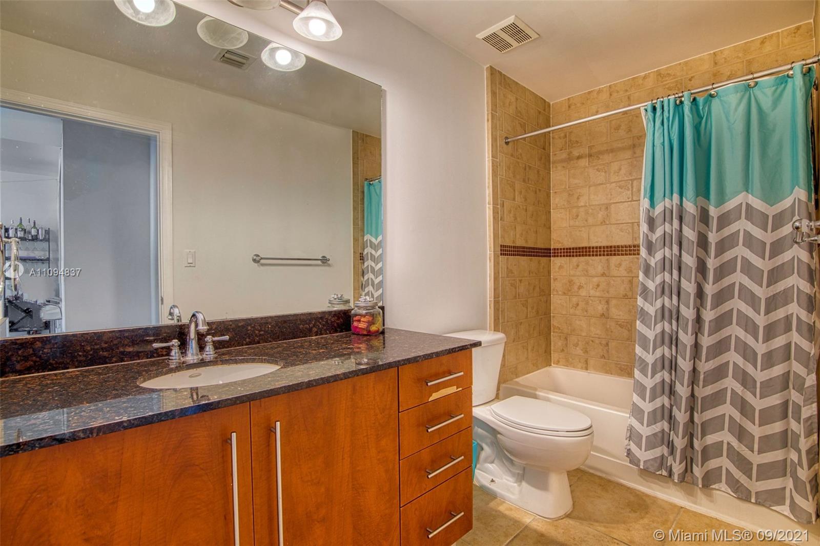 7355 Southwest 89th Street, Unit 425N Miami, FL 33156 - Photo 9 of 22 a bathroom with a granite countertop sink toilet and shower