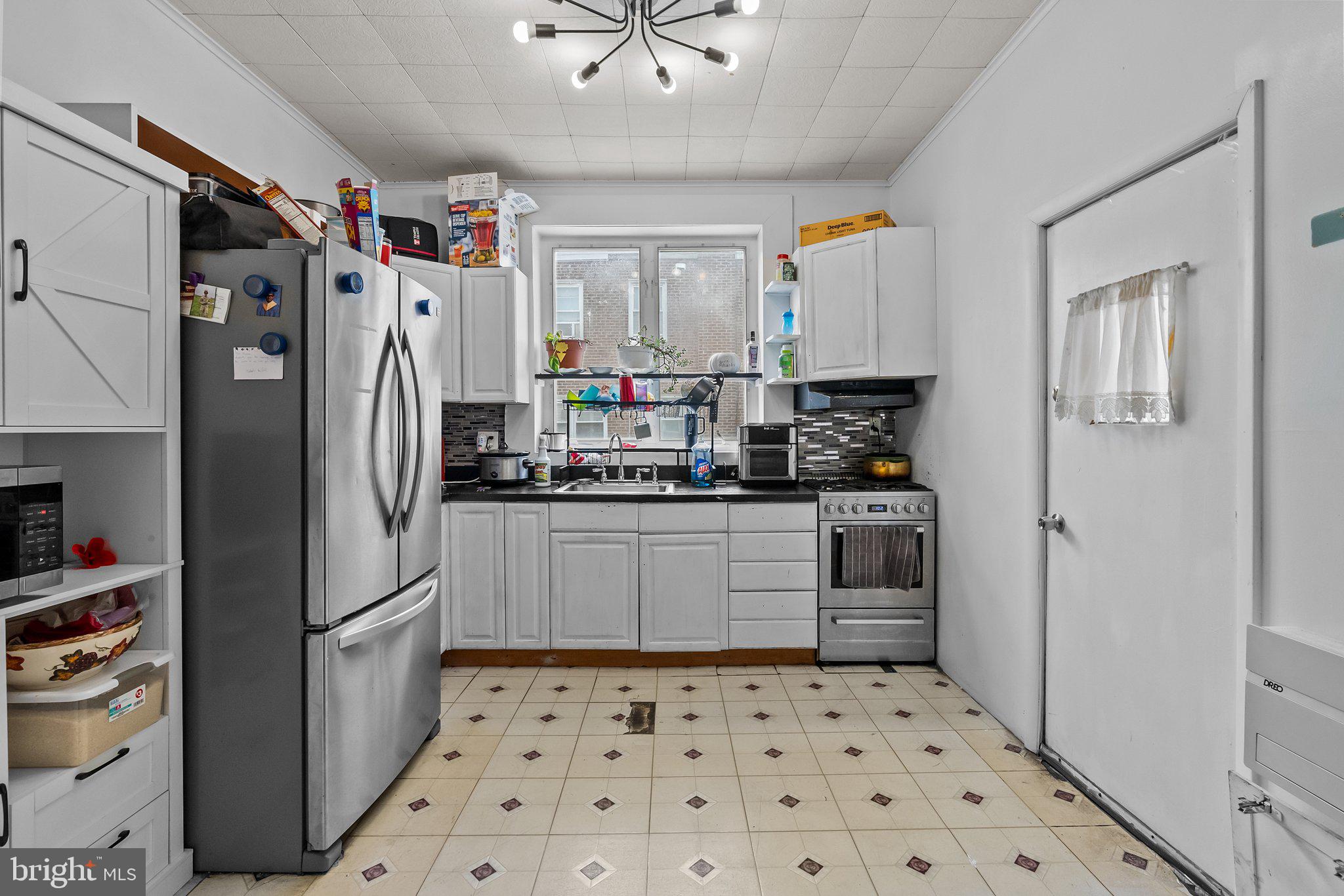 4620 Decatur Street Philadelphia, PA 19136 - Photo 8 of 20 a kitchen with stainless steel appliances a refrigerator and a stove top oven