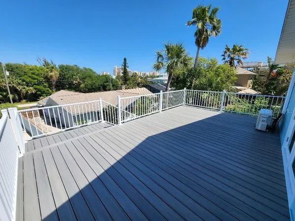 a view of balcony with wooden floor and seating space
