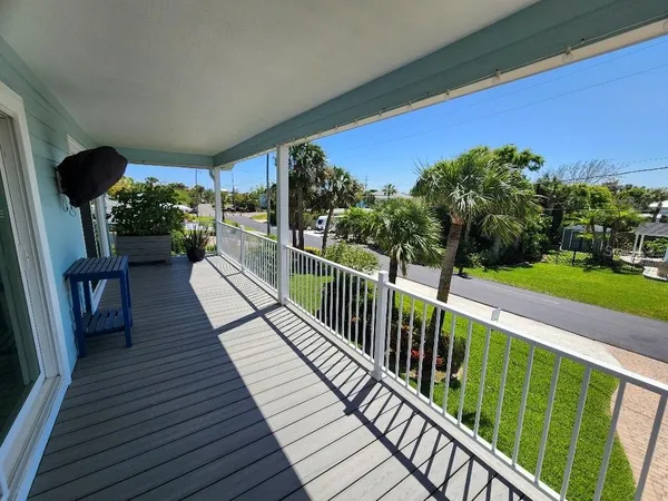 a view of balcony with wooden floor and outdoor seating
