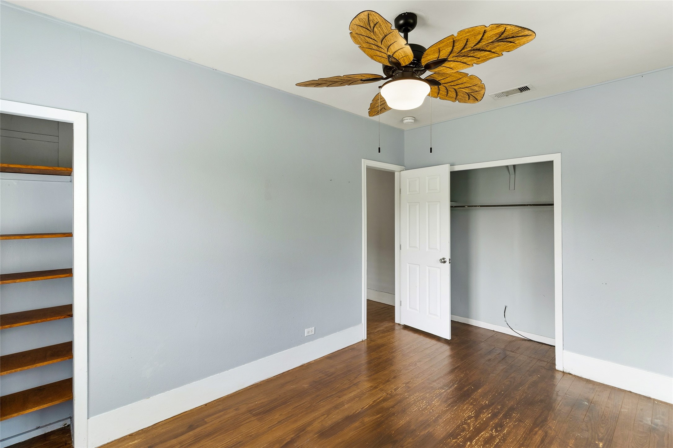 12903 Sandpiper Road Angleton, TX 77515 - Photo 16 of 19 A spacious closet and built-in shelving provide practical storage while maintaining the room's comfortable layout.