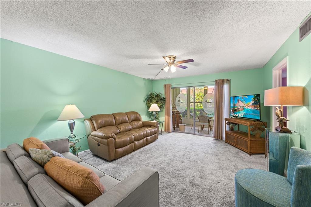 300 Valley Stream Drive, Unit A1 Naples, FL 34113 - Photo 15 of 27 a living room with furniture and a flat screen tv