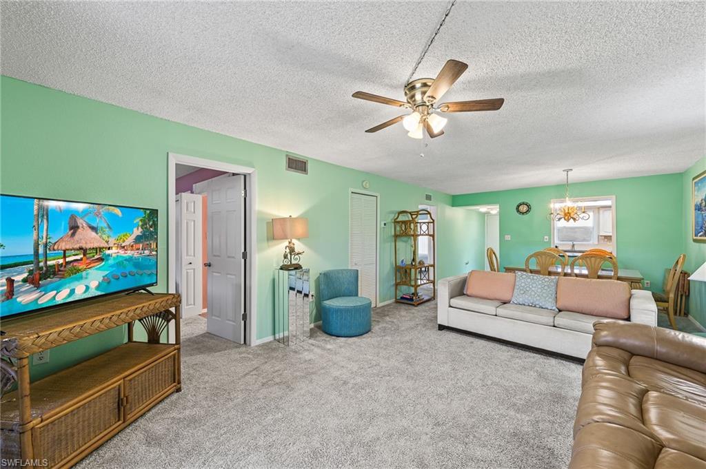 300 Valley Stream Drive, Unit A1 Naples, FL 34113 - Photo 17 of 27 a living room with furniture and a flat screen tv