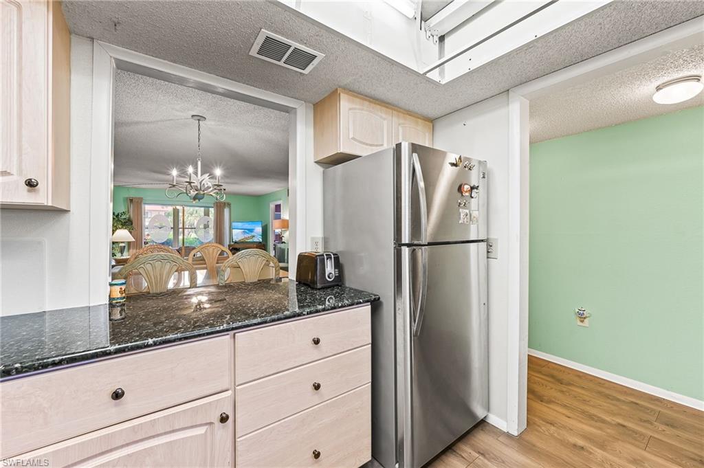 300 Valley Stream Drive, Unit A1 Naples, FL 34113 - Photo 18 of 27 a kitchen with a refrigerator and countertop