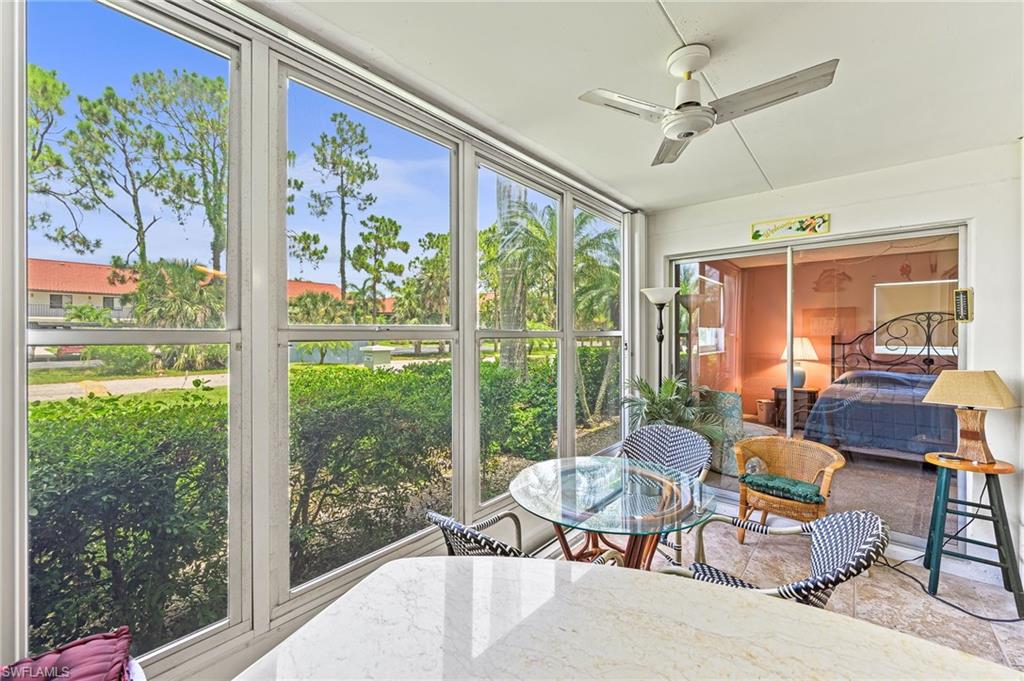 300 Valley Stream Drive, Unit A1 Naples, FL 34113 - Photo 2 of 27 a living room with furniture and a large window