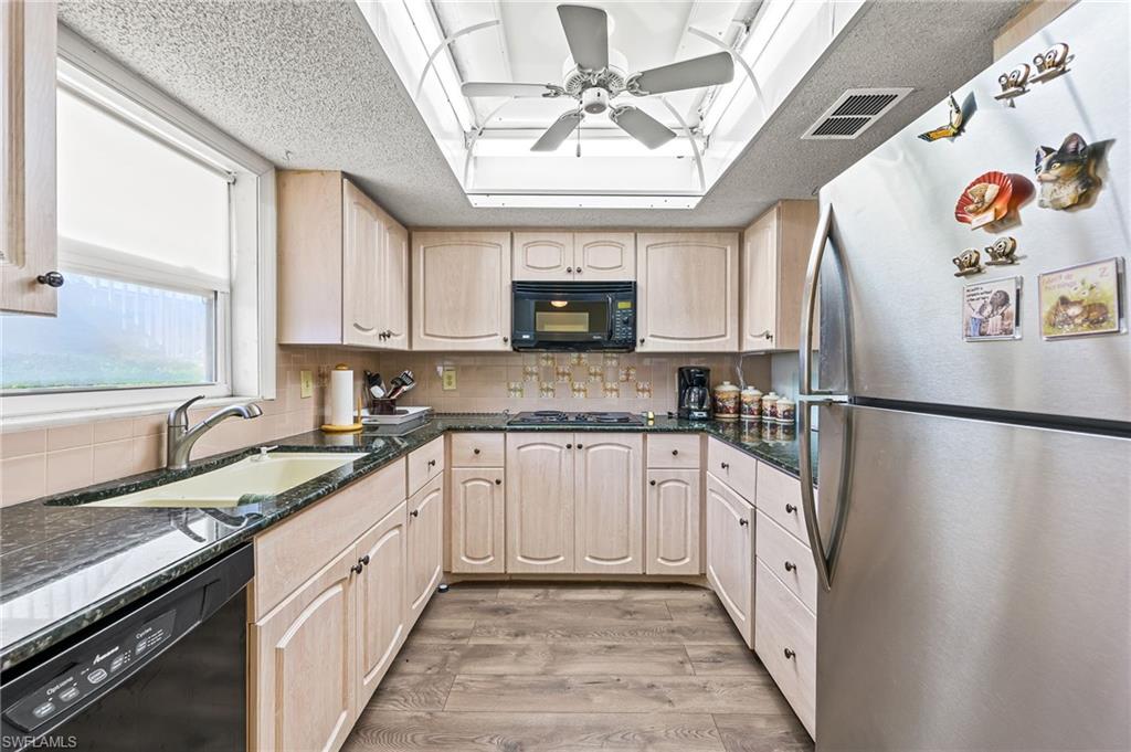 300 Valley Stream Drive, Unit A1 Naples, FL 34113 - Photo 23 of 27 a kitchen with granite countertop a refrigerator and a sink