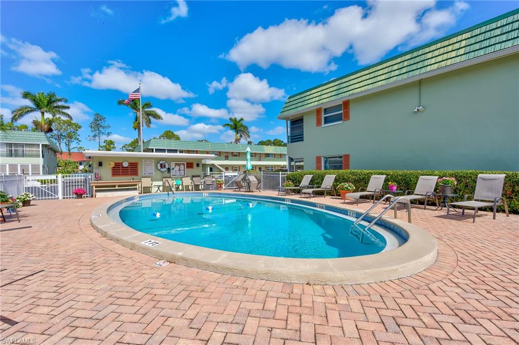 300 Valley Stream Drive, Unit A1 Naples, FL 34113 - Photo 27 of 27 a view of outdoor space with swimming pool and seating
