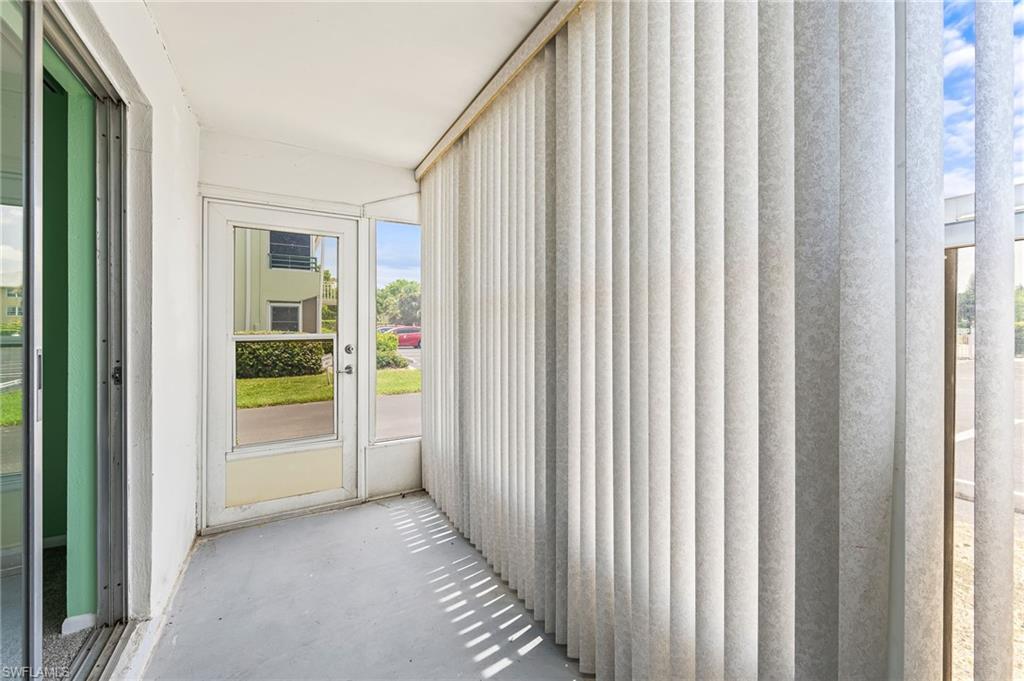 300 Valley Stream Drive, Unit A1 Naples, FL 34113 - Photo 3 of 27 a view of an empty room with a window