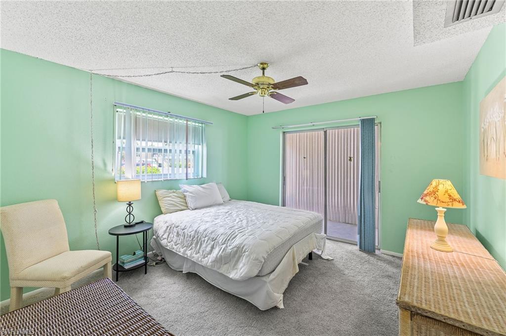 300 Valley Stream Drive, Unit A1 Naples, FL 34113 - Photo 6 of 27 a bedroom with a bed couch and window