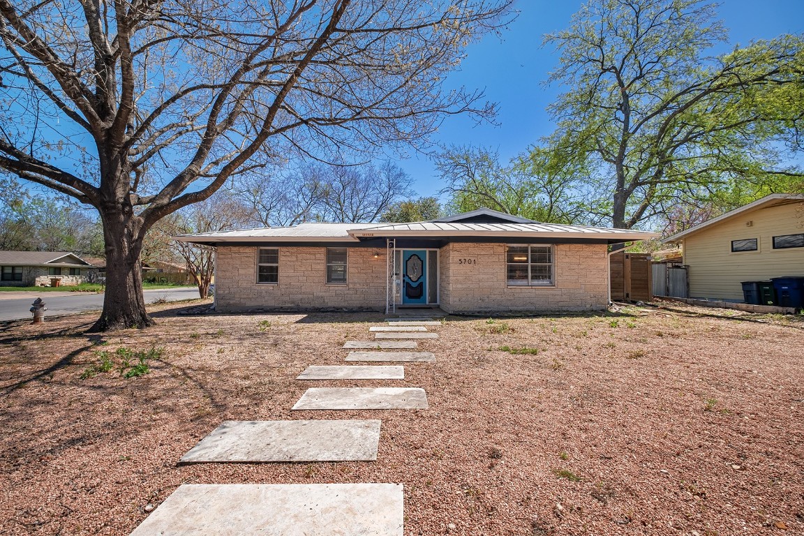 a view of a house with a yard and trees