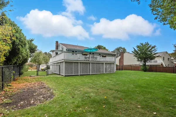 a view of a house with a yard and sitting area