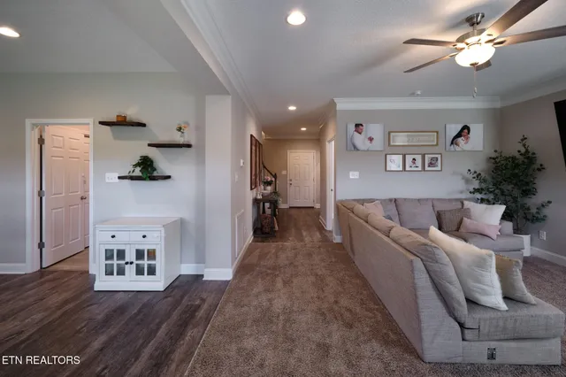 a living room with furniture and a wooden floor