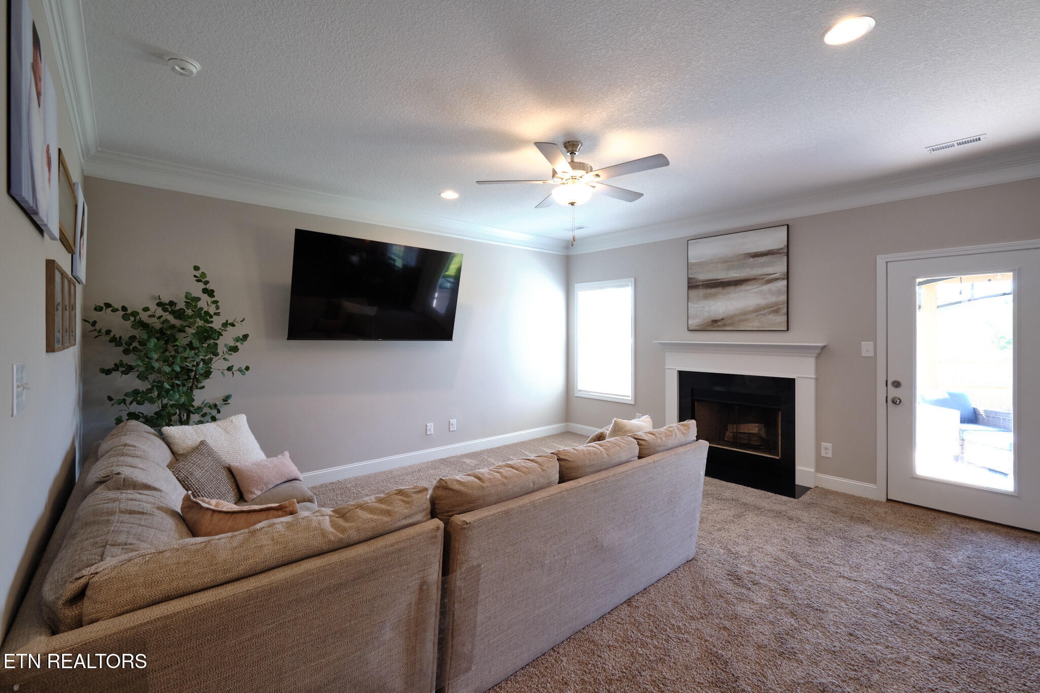 8155 Zenith Lane Powell, TN 37849 - Photo 12 of 45 a living room with furniture a fireplace and a flat screen tv