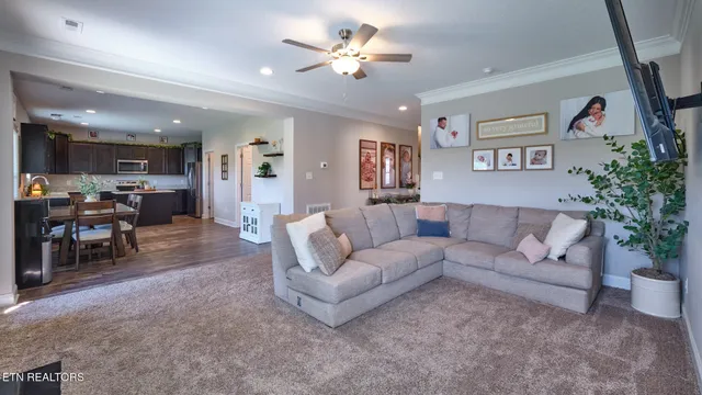 a living room with furniture and kitchen view