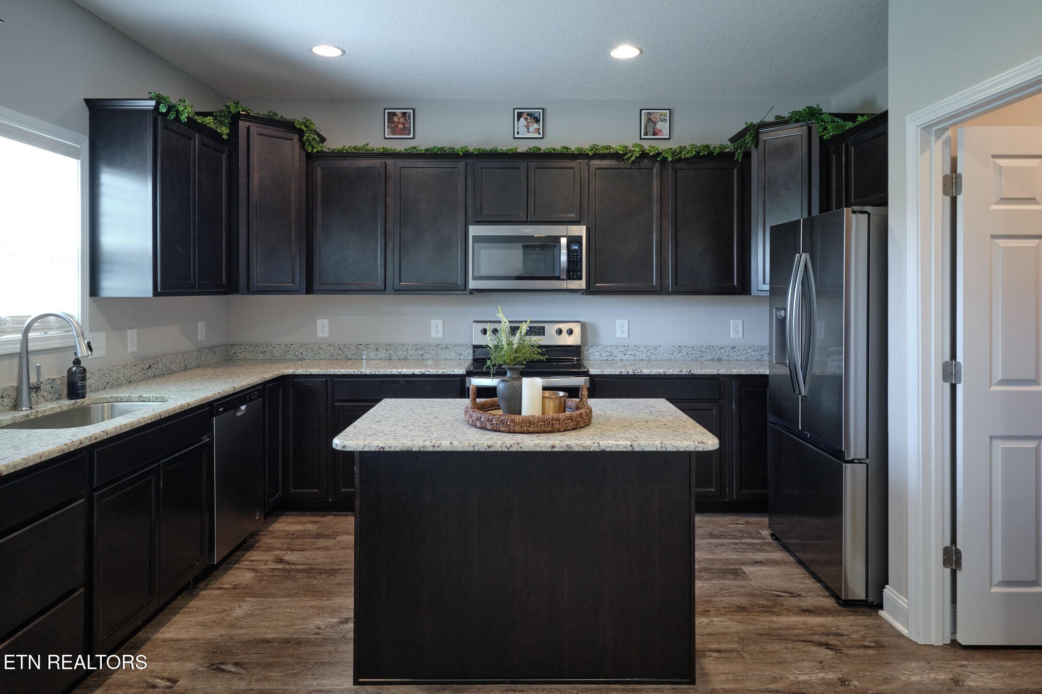 8155 Zenith Lane Powell, TN 37849 - Photo 16 of 45 a kitchen with kitchen island a sink refrigerator and microwave