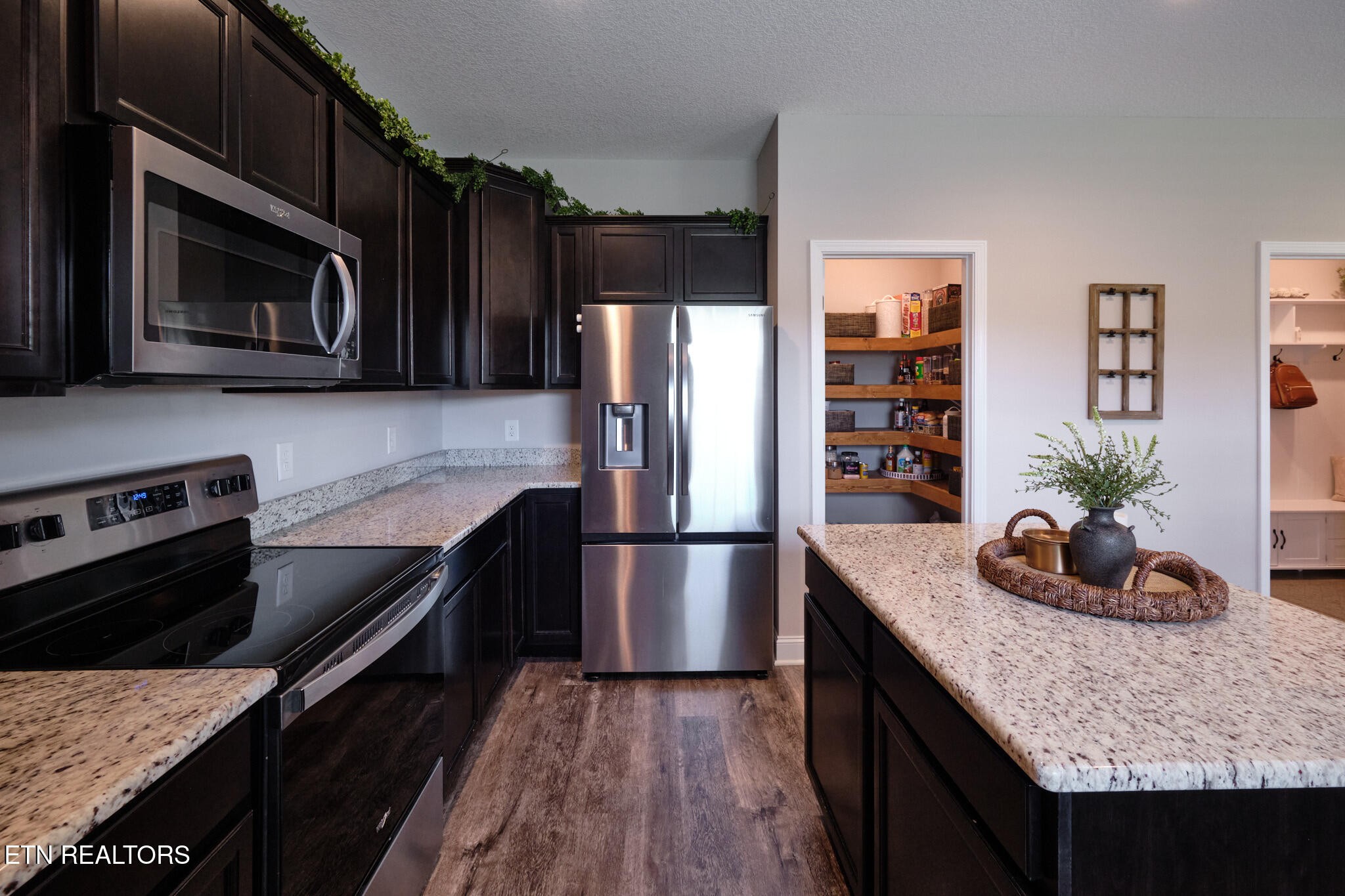 8155 Zenith Lane Powell, TN 37849 - Photo 17 of 45 a kitchen with granite countertop a stove microwave and refrigerator