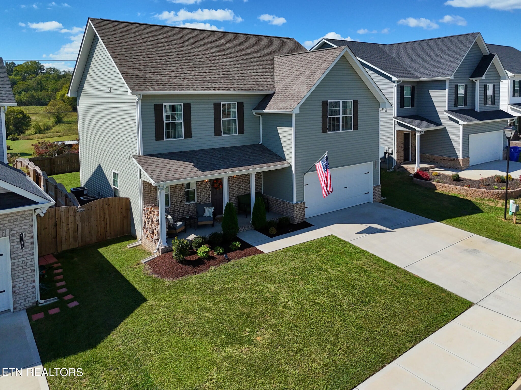 8155 Zenith Lane Powell, TN 37849 - Photo 2 of 45 a front view of a house with a yard table and chairs