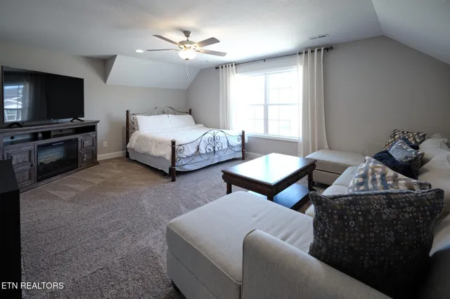 a bedroom with furniture and a flat screen tv