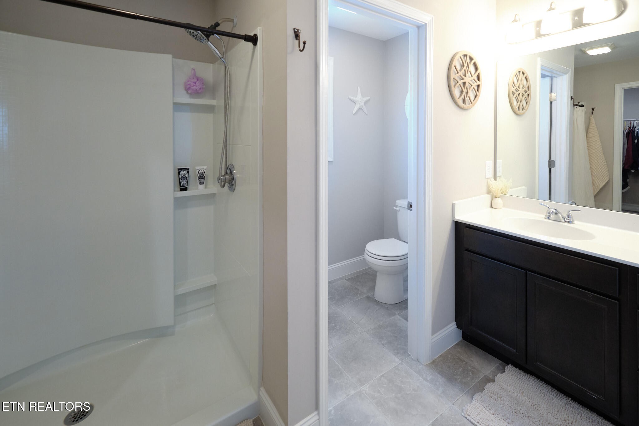 8155 Zenith Lane Powell, TN 37849 - Photo 28 of 45 a bathroom with a sink a toilet a shower and a mirror