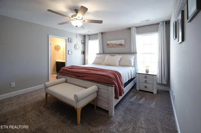 a spacious bedroom with a bed and a chandelier