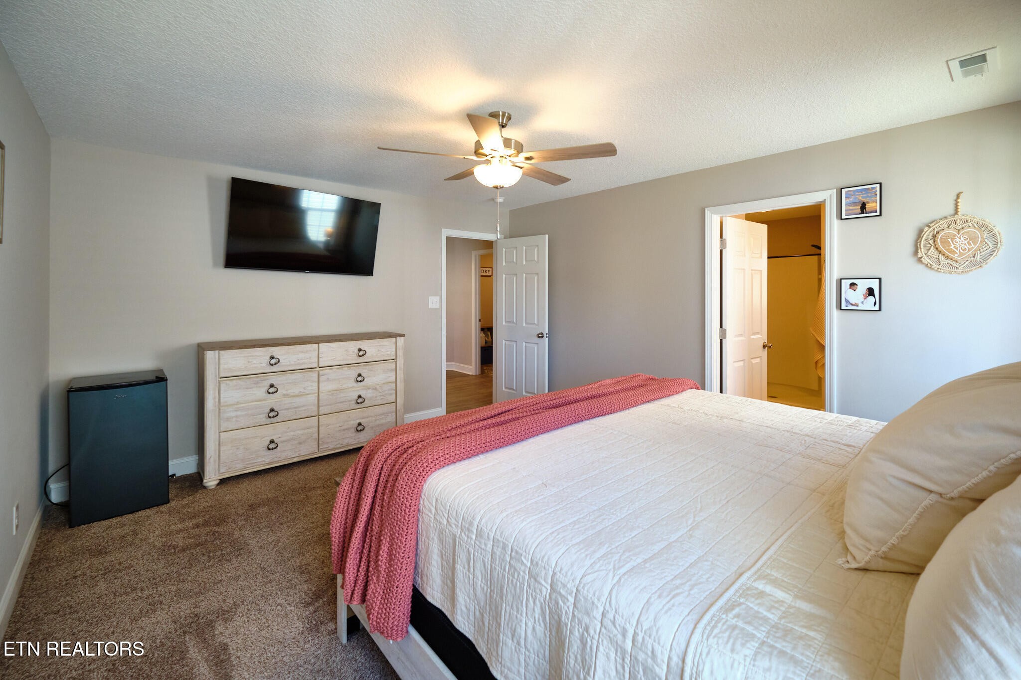 8155 Zenith Lane Powell, TN 37849 - Photo 30 of 45 a bedroom with a large bed and a flat screen tv