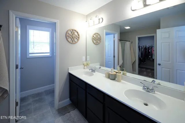 a bathroom with a double vanity sink and a mirror