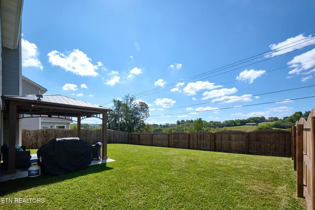a view of backyard with trampoline