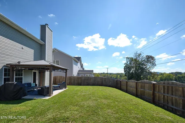 a view of a house with backyard and porch