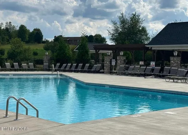 a swimming pool view with a outdoor seating