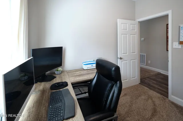 a view of a workspace with furniture