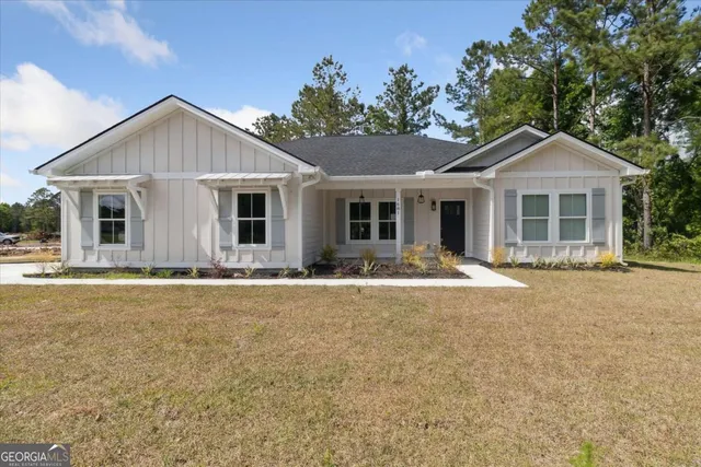 a front view of house with yard and green space