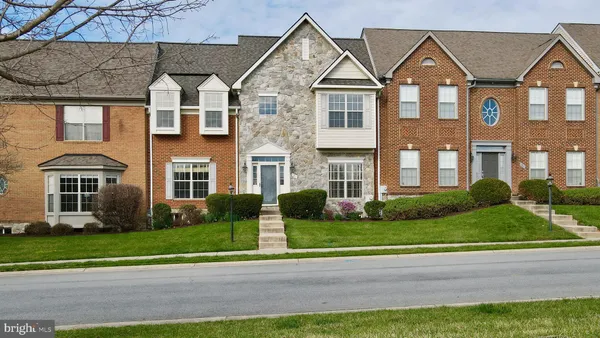 a view of a brick house with a yard