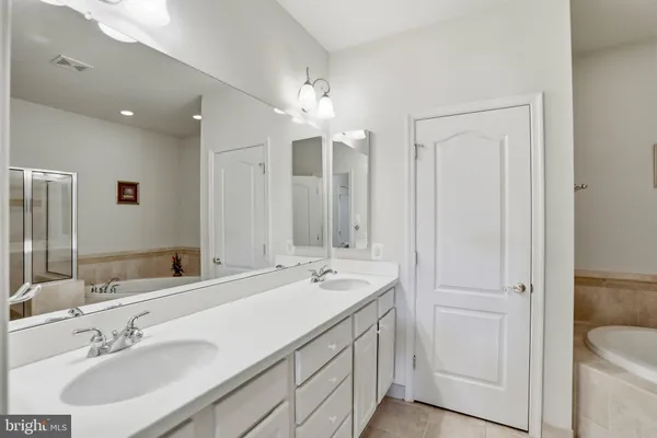 a bathroom with a sink double vanity and a mirror