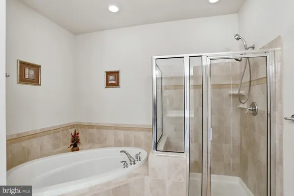 a bathroom with a bathtub and shower