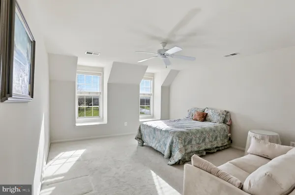 a living room with a bed furniture and a window