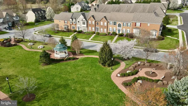 an aerial view of a house with garden space ocean and mountain view in back