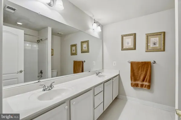 a bathroom with a double vanity sink and a mirror