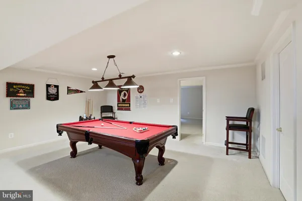 a room with furniture and pool table