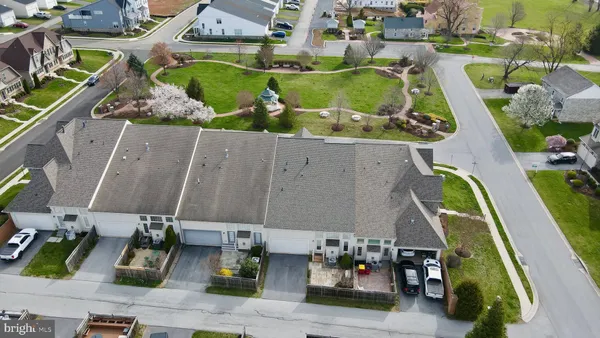 an aerial view of residential houses with outdoor space