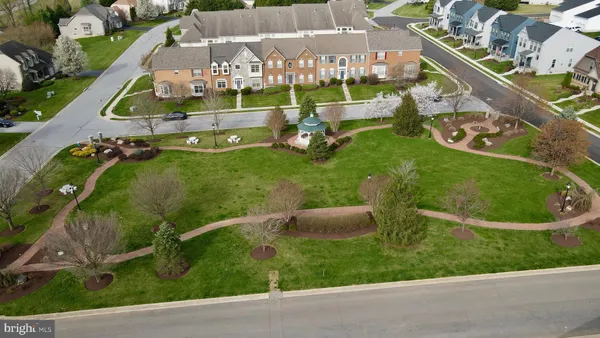 an aerial view of a house with swimming pool garden and outdoor seating